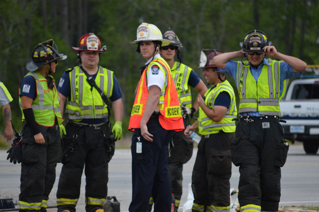 A Group of the Fire and Rescue Team Standing in Vests and Hard Hats