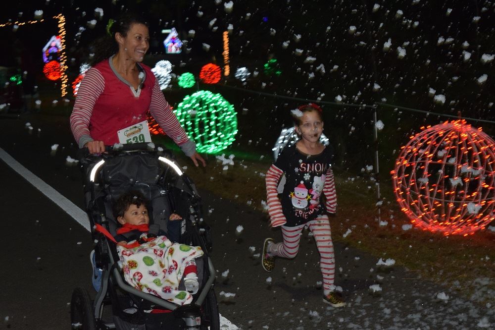 A Mom Running with Her Two Children in Snow